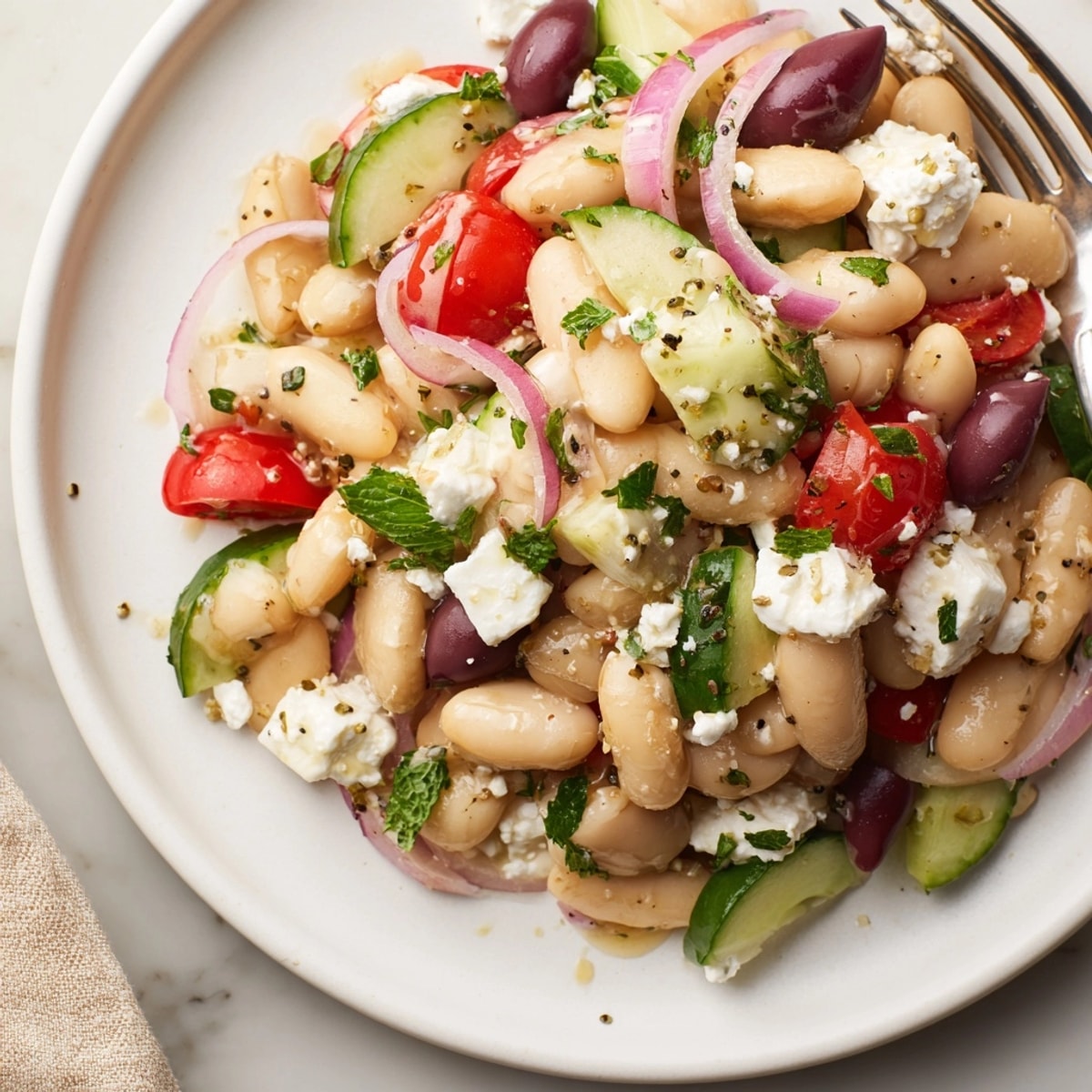 Close-up of a vibrant Mediterranean White Bean Salad with Feta, showcasing colorful vegetables.