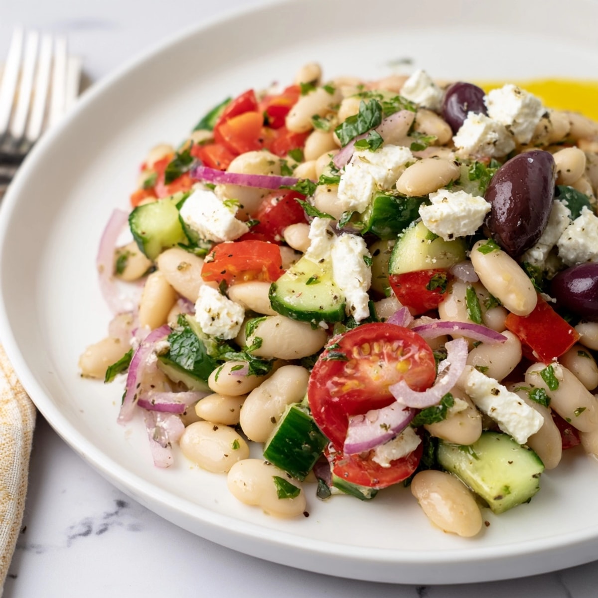 Creamy Mediterranean White Bean Salad with Feta, drizzled with olive oil, ready to serve!