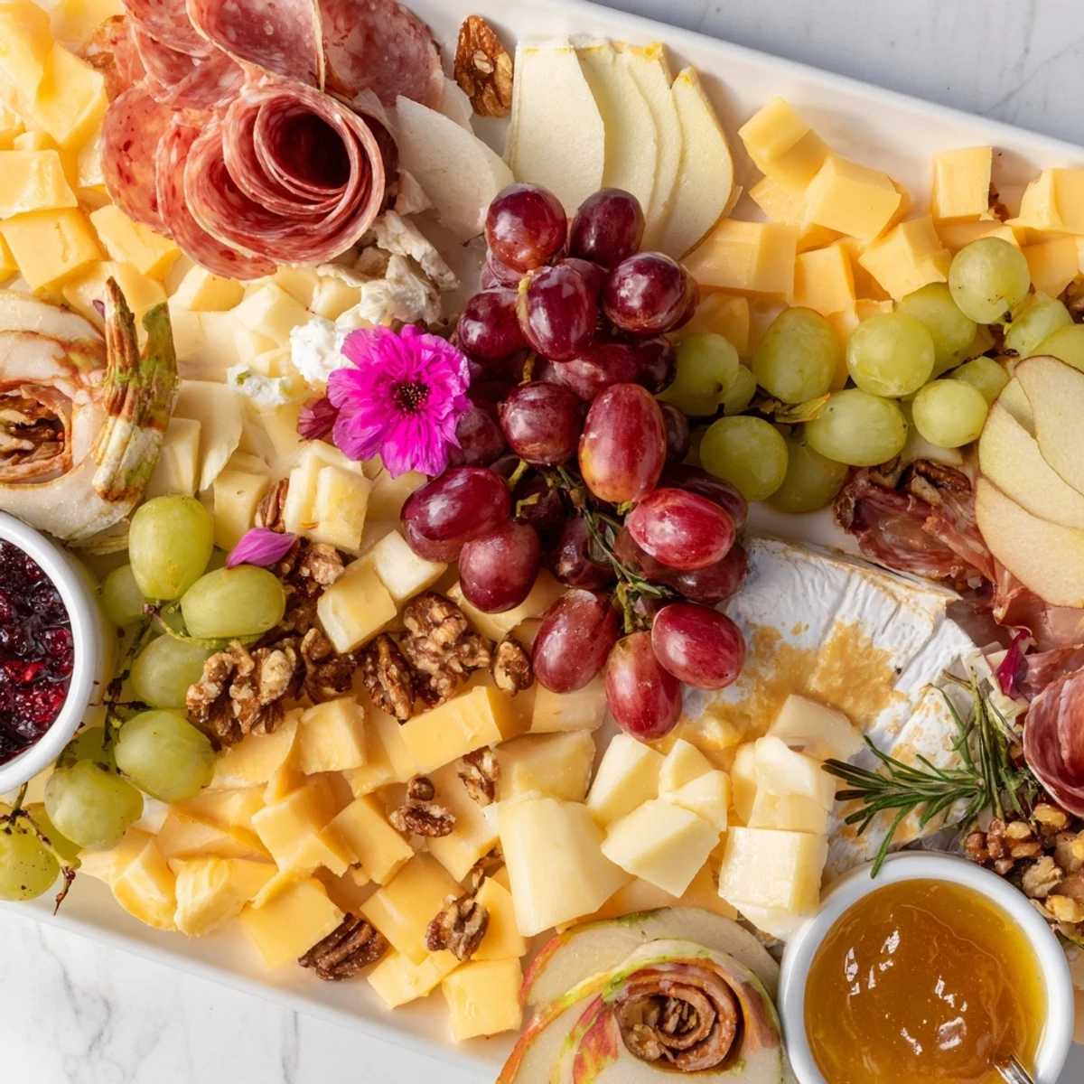 Vibrant autumn Maple Leaf Grazing Tray: Cheeses, meats, fruits, and nuts arranged in a festive shape.
