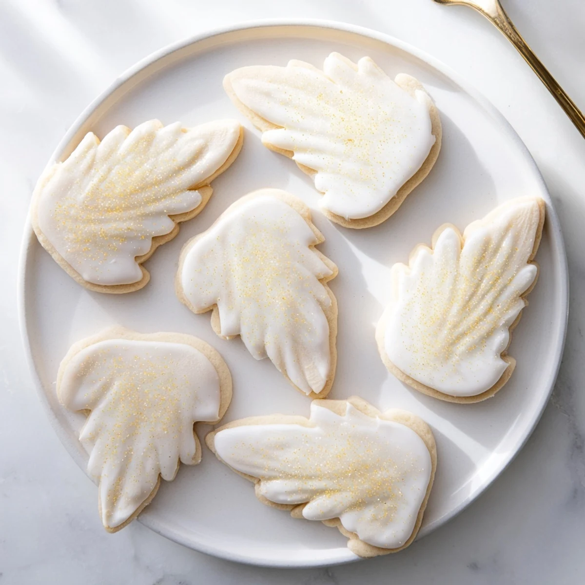 Delicate Angel Wings sugar cookies, adorned with sparkling sprinkles and ready for a festive treat.