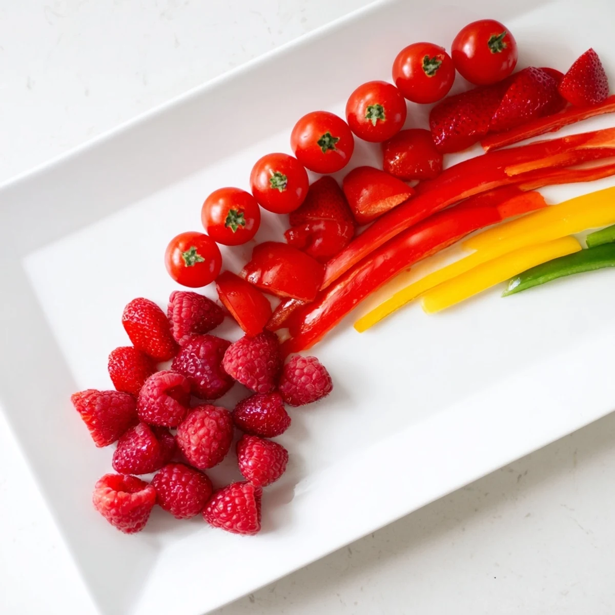 Colorful Rainbow Pride Spectrum grazing board, beautifully arranged with vibrant fruits and vegetables for parties.