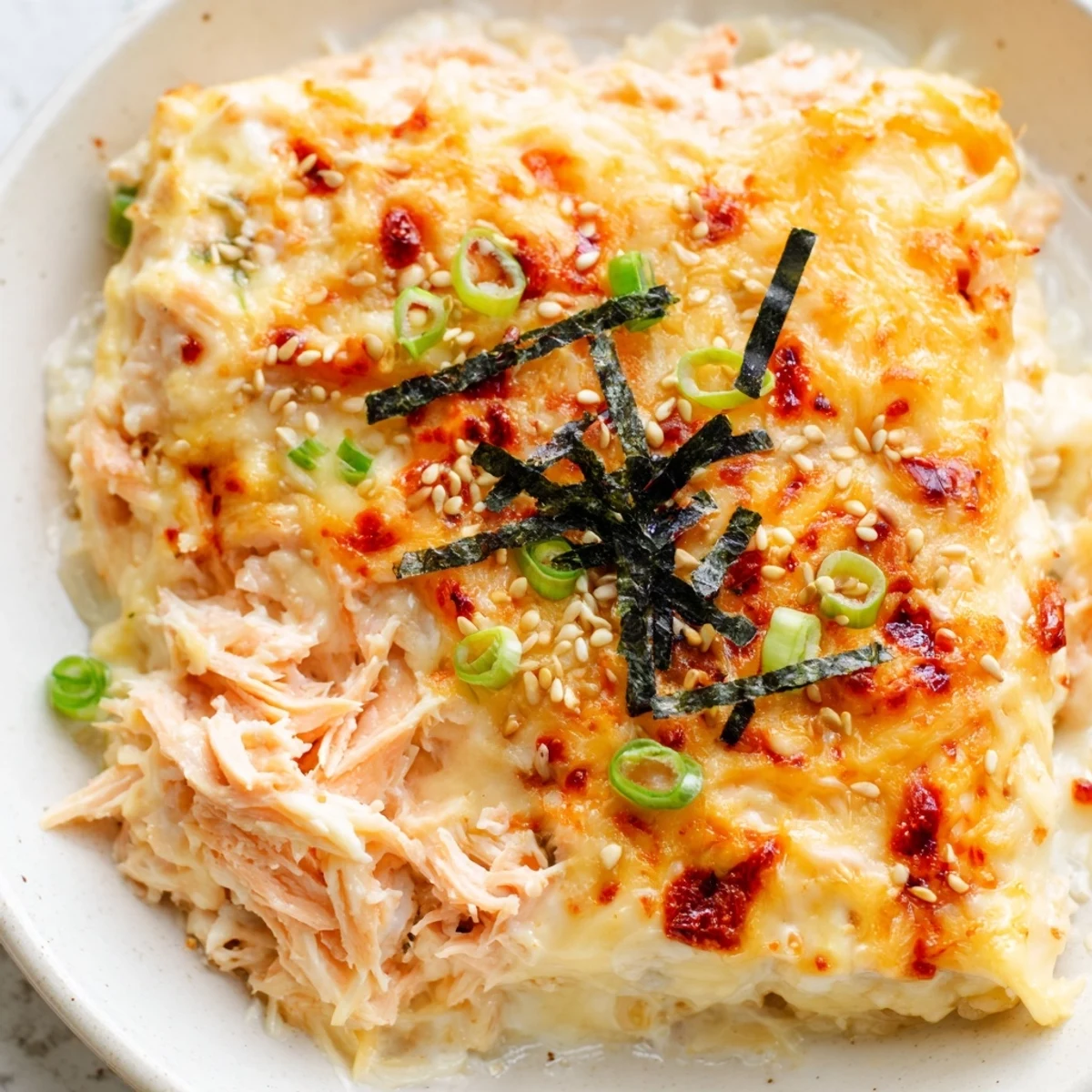 Golden, bubbly Creamy Salmon Sushi Bake, a deconstructed sushi casserole with fragrant sesame seeds.