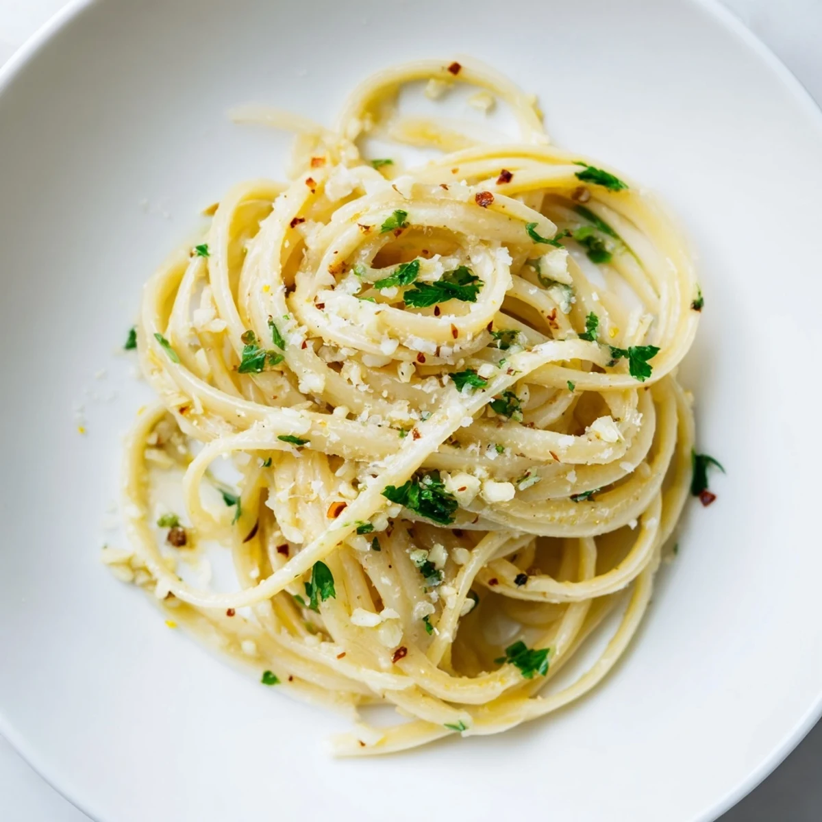Silky garlic butter coats perfectly cooked linguine, ready to devour with a squeeze of lemon.