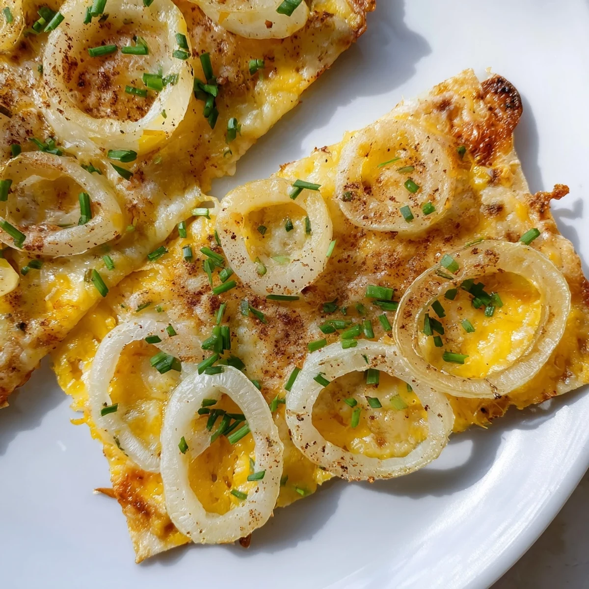 Close-up of freshly made crispy onion cheese chips; imagine the flavorful, savory, air-fried goodness.