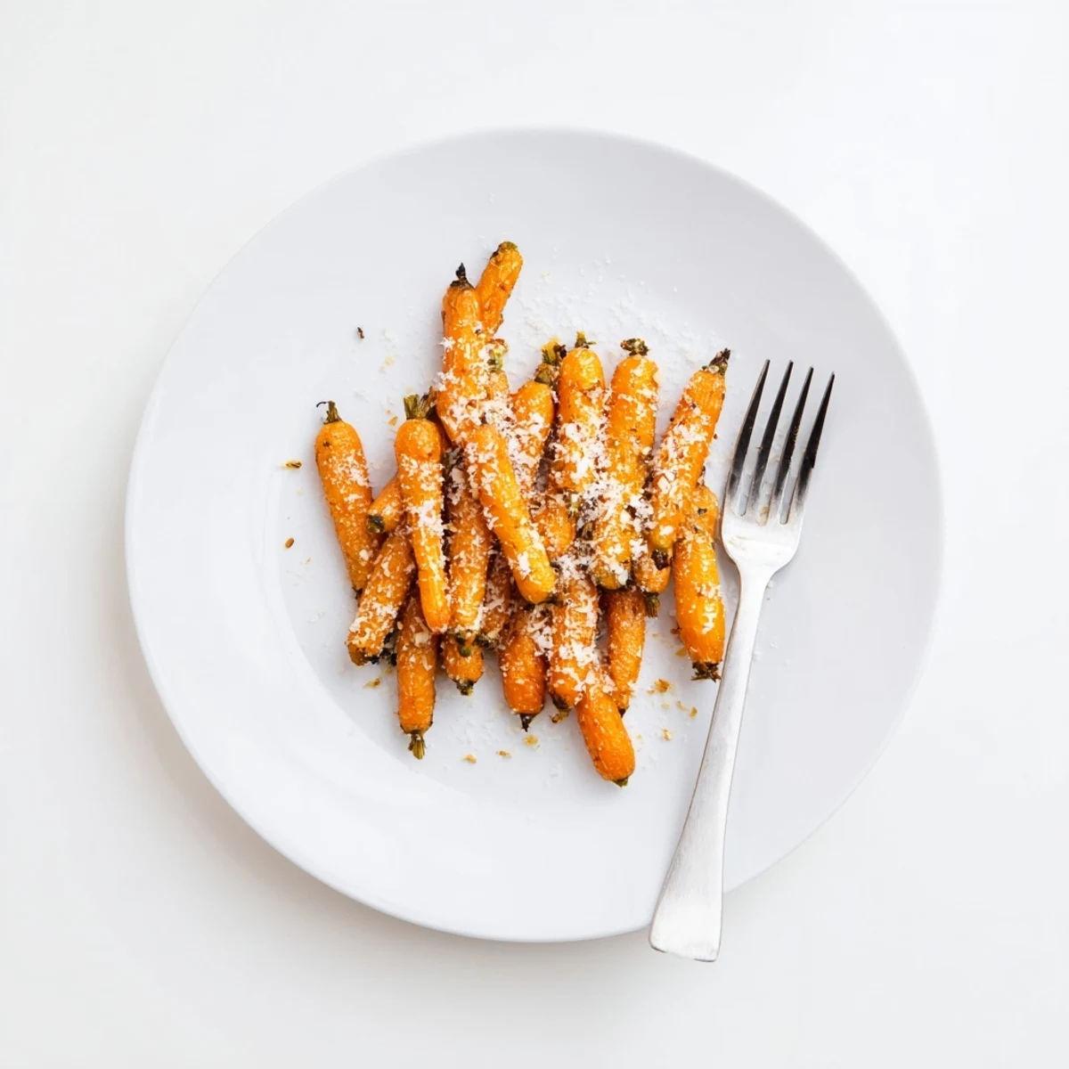 Perfectly roasted Parmesan baby carrot chips, golden and crisp, served as a tasty side dish.