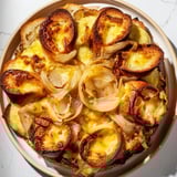 A close-up shot of French Onion Pot Roast Casserole, showcasing the tender beef and caramelized onions.