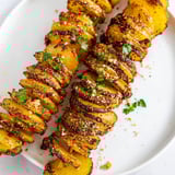 Close-up of freshly baked Tornado Potatoes; savory spices and the perfect crispy texture.