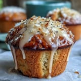 Fluffy lemon poppy seed muffins topped with a bright citrus glaze, perfect for a sunny spring brunch spread.