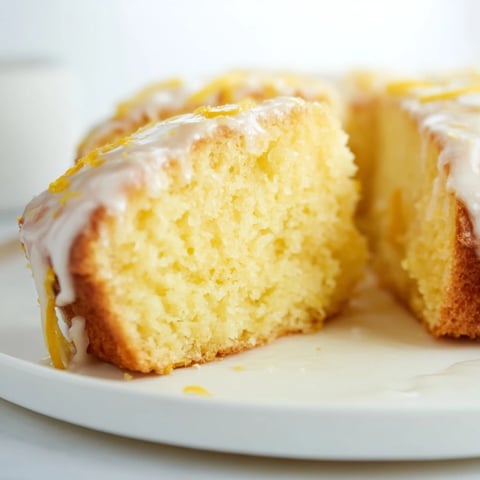 Fluffy Lemon Yogurt Cake, glazed and ready to eat, perfect for an afternoon tea treat.