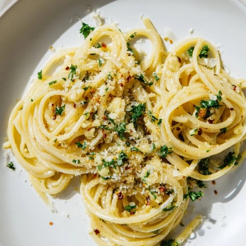 Golden garlic butter linguine, tossed with fresh parsley, looks incredibly tempting on the plate.