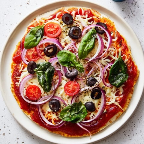 Golden and crispy-edged Crispy Tortilla Pizza, generously topped with melted mozzarella cheese and black olives.