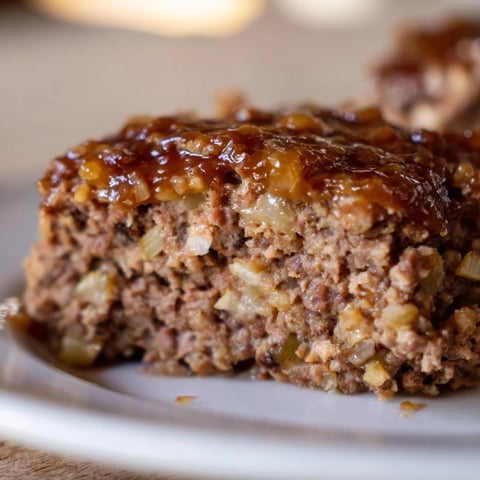 Individual mini meatloaf bites, tender and juicy, glistening under a sweet maple-mustard glaze.