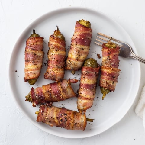 Freshly baked bacon-wrapped pickles served warm with a side of ranch dressing for dipping.