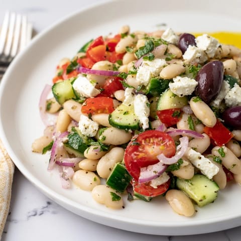 Creamy Mediterranean White Bean Salad with Feta, drizzled with olive oil, ready to serve!