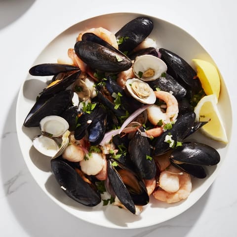 Tender shrimp and scallops in this vibrant Shellfish & Seafood Medley, cooked with white wine and garlic.