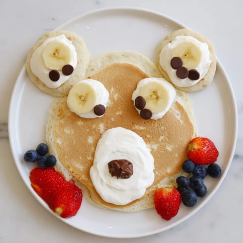 A beautiful, colorful Polar Bear Pancake Stack Board with pancakes styled to look like bears, ready to serve.