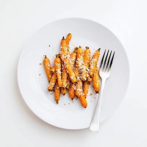 Perfectly roasted Parmesan baby carrot chips, golden and crisp, served as a tasty side dish.