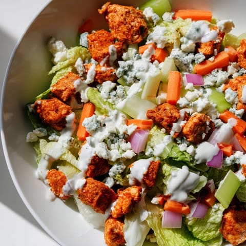 Bright, fresh Buffalo Chicken Chopped Salad topped with crumbled blue cheese and drizzled with ranch dressing.