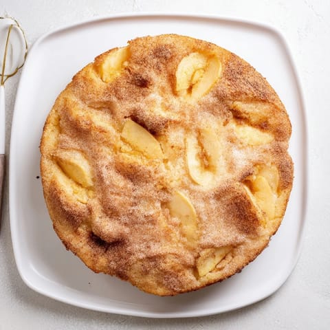 A rustic Baked Apple Cake with cinnamon-topped crumbs, warm from the oven for breakfast.