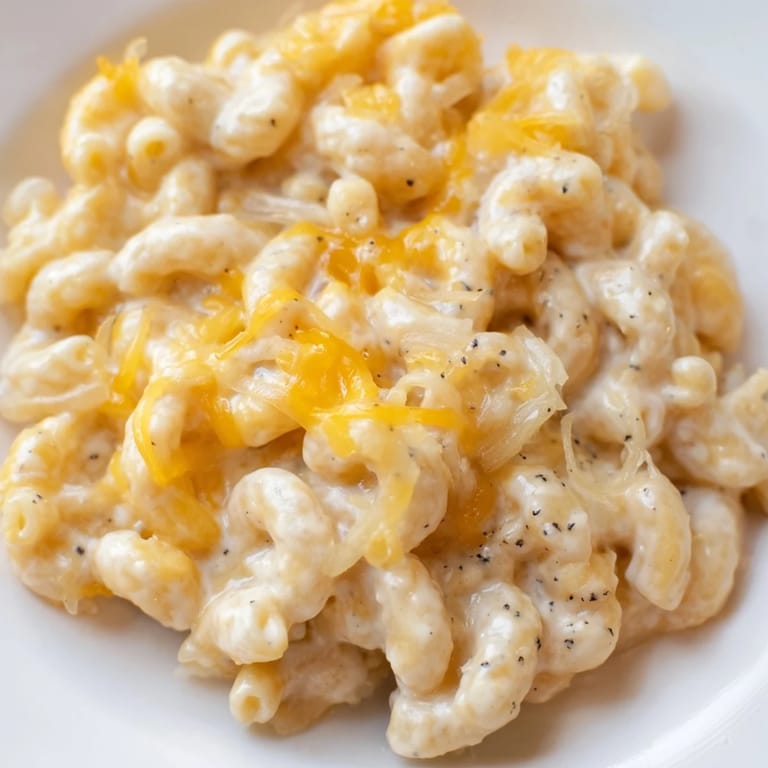Close-up of golden-orange one-pot butternut squash mac & cheese, a comforting vegetarian meal perfect for dinner.