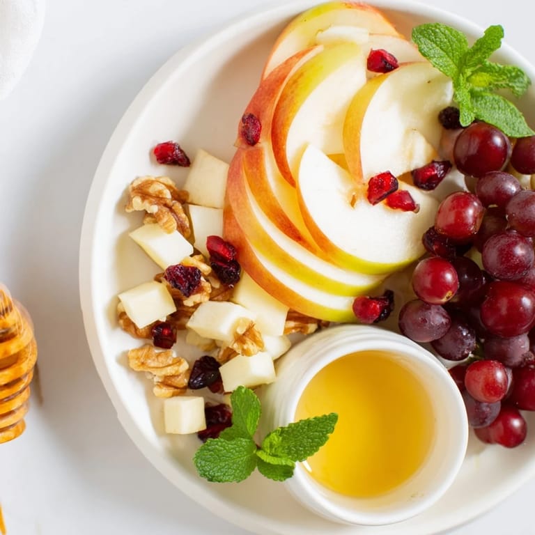 See a close-up of this delicious Apple Orchard Fruit Board, featuring fresh fruit and sweet honey for dipping.