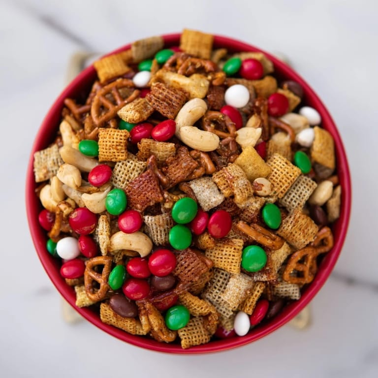 A festive cluster of Holiday Mix in a red and green bowl, hinting at the delightful holiday flavors.