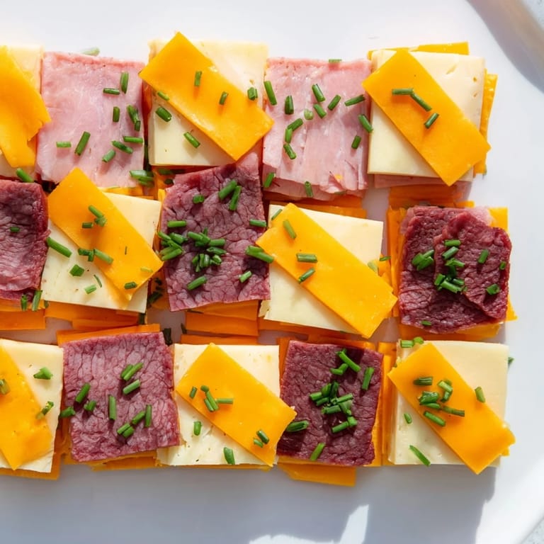 Enjoy visually stunning Checkerboard Picnic Bites, an easy-to-make platter featuring delicious deli meats and cheeses.