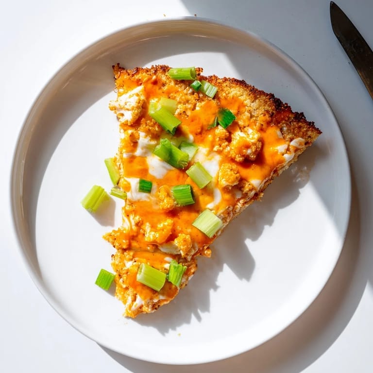 Freshly baked Buffalo Cauliflower Pizza with a crispy cauliflower crust and bubbly cheese, ready to serve for dinner.