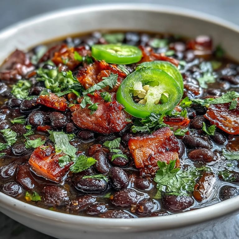 Smoky diced ham and black beans simmer with jalapeños in this hearty, spicy soup, perfect for warming up on chilly days.