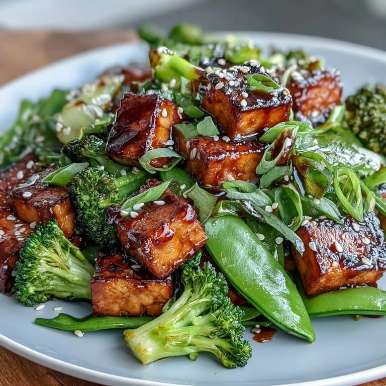 Crispy tofu cubes and vibrant vegetables are tossed in rich teriyaki sauce, creating a wholesome and flavorful vegan stir-fry.
